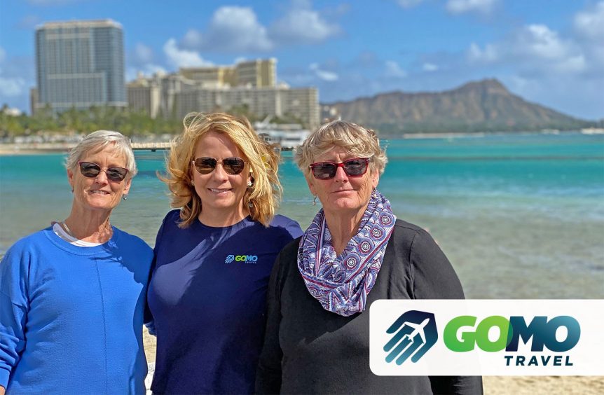 Kerri Johnson posing with happy clients with ocean and city skyline in the background