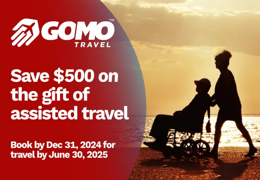 $500 Holiday Savings on Assisted Travel - Man in wheelchair on beach with GOMO Travel Companion